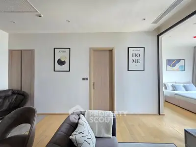 Modern living room with stylish decor and glimpse of cozy bedroom
