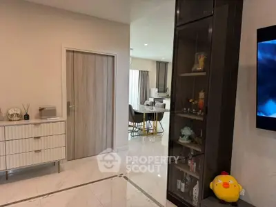 Modern living room with stylish decor and open layout, featuring sleek furniture and elegant flooring.