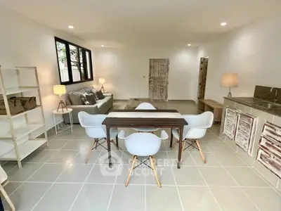 Spacious modern living room with stylish dining area and open kitchen layout.
