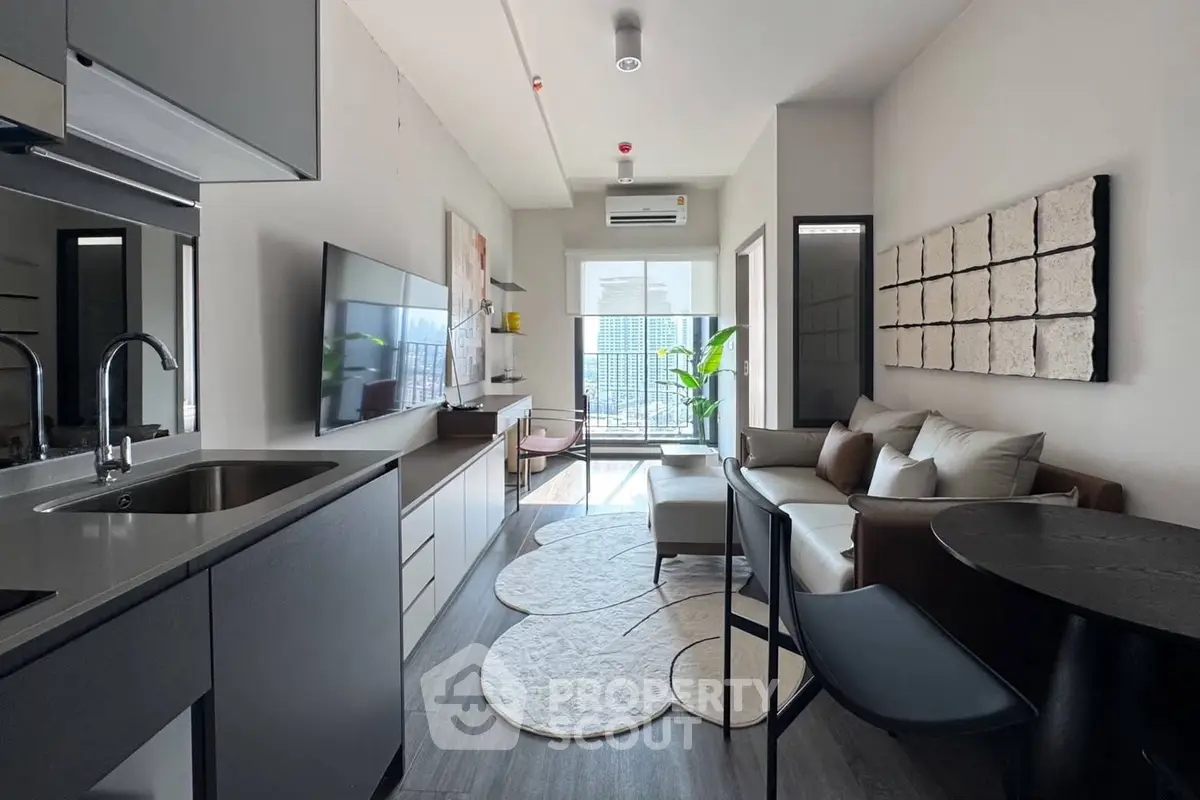 Modern living room with sleek kitchen and balcony view in urban apartment