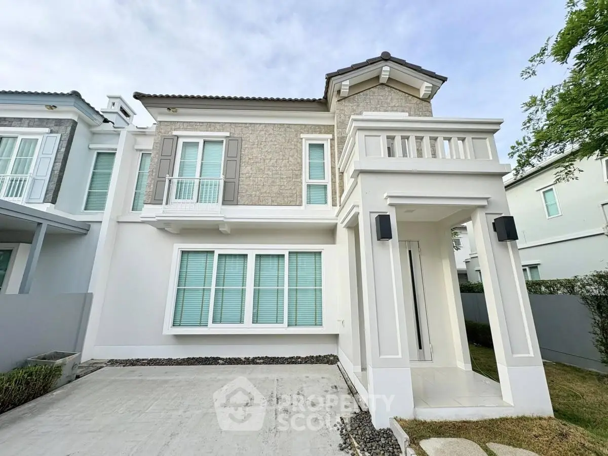 Elegant two-story house with modern facade and spacious driveway in a serene neighborhood.