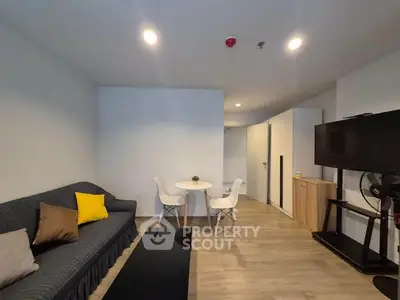 Modern living room with cozy sofa, stylish decor, and flat-screen TV, perfect for relaxation and entertainment.
