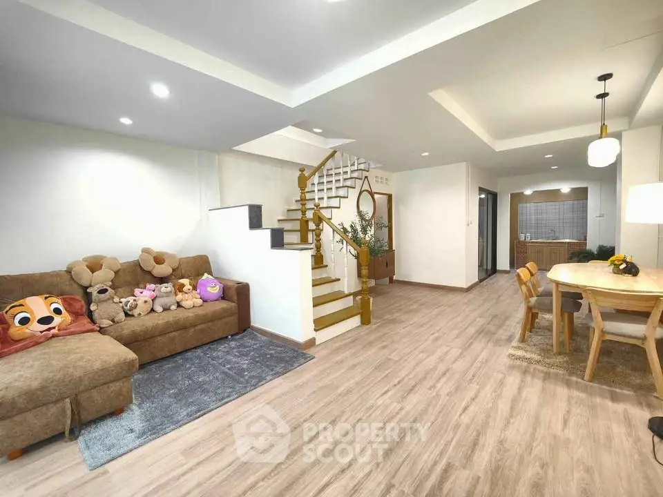Spacious modern living room with cozy sofa and dining area