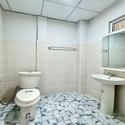 Modern bathroom with white tiles and pedestal sink