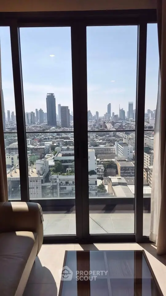 Stunning cityscape view from modern high-rise apartment balcony.