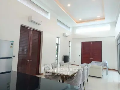 Spacious modern living room with high ceilings and elegant dining area