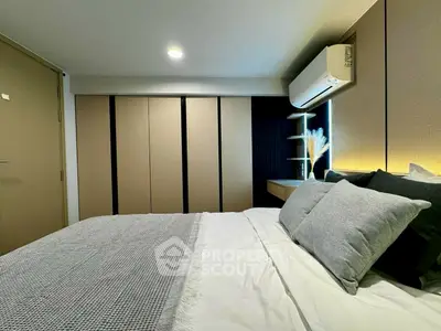 Modern bedroom with sleek design, featuring cozy bedding and ambient lighting for a relaxing atmosphere.