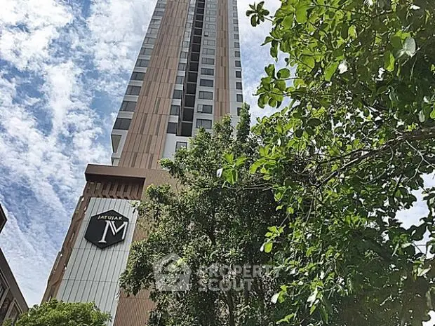 Stunning high-rise building with modern architecture and lush greenery.
