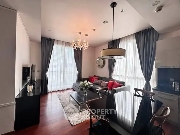 Elegant living room with modern decor, large windows, and stylish furniture in a high-rise apartment.