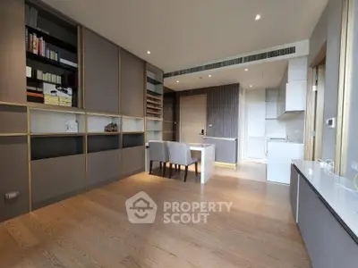 Modern open-plan living room with sleek wooden flooring and built-in shelving, perfect for stylish urban living.