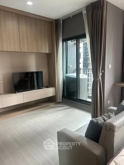 Modern living room with balcony access and sleek entertainment unit