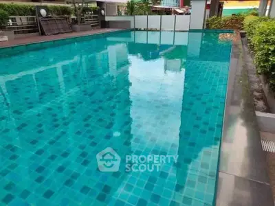 Luxurious rooftop pool with stunning city views and lush greenery.