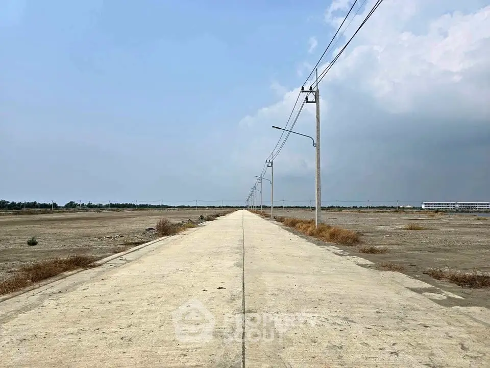 Expansive land plot with clear skies, ideal for development opportunities.