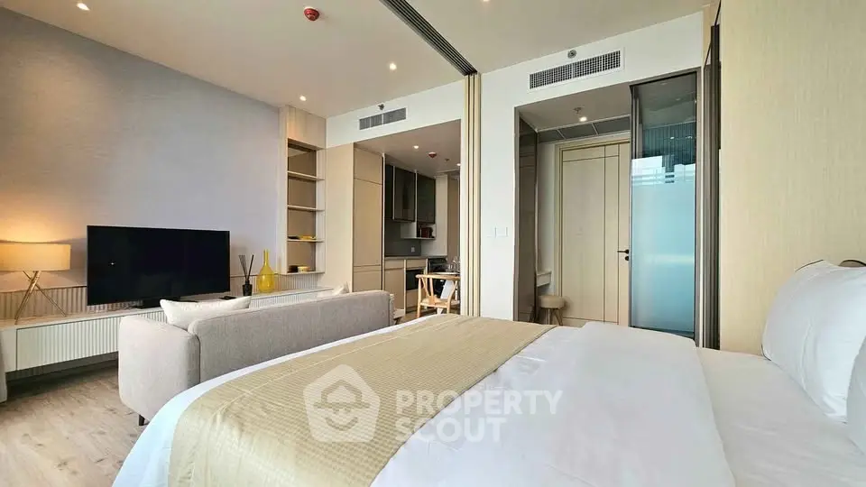 Modern studio apartment with cozy living area and sleek kitchen design