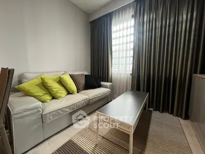Cozy living room with modern sofa and stylish curtains, perfect for relaxation.