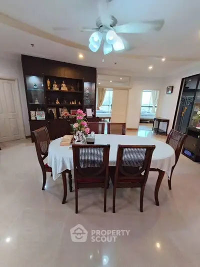 Elegant dining room with wooden furniture and decorative shelving, perfect for family gatherings.