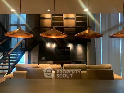 Luxurious modern living room with stylish lighting and elegant staircase