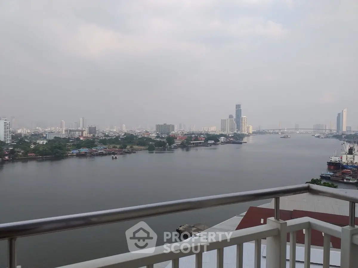 Stunning river view from a high-rise balcony in a modern cityscape.