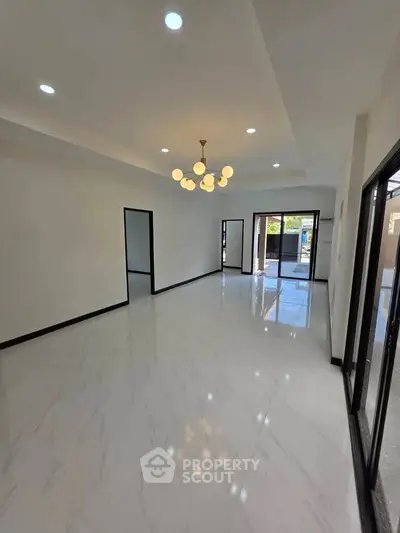 Spacious modern living room with elegant lighting and large windows for natural light.