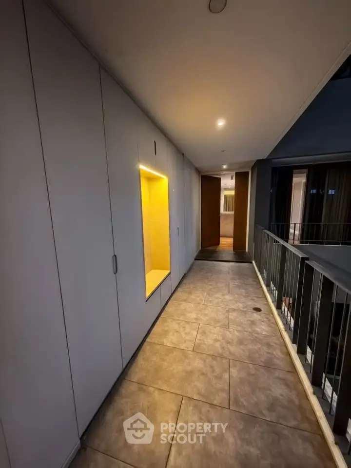 Modern apartment corridor with sleek design and ambient lighting