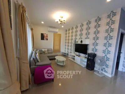 Stylish living room with modern decor, featuring a cozy sectional sofa, elegant wallpaper, and a sleek entertainment center.