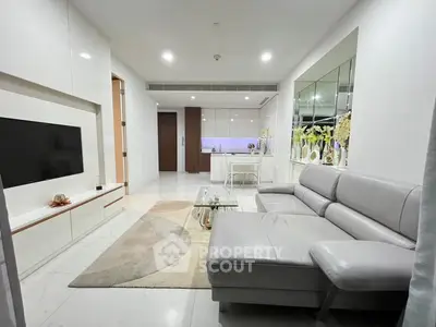 Modern living room with sleek furniture and open kitchen layout