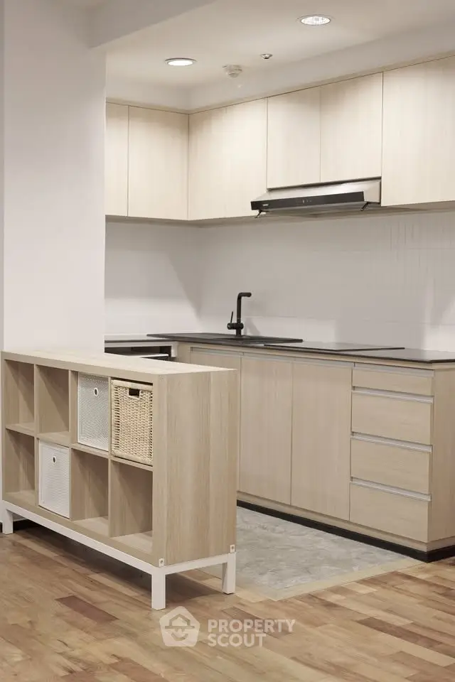Modern kitchen with sleek cabinetry and open layout in a stylish apartment.