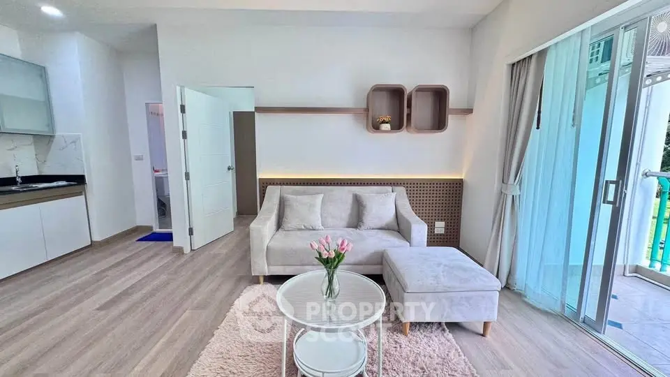 Modern living room with stylish decor and natural light, featuring a cozy sofa and elegant coffee table.