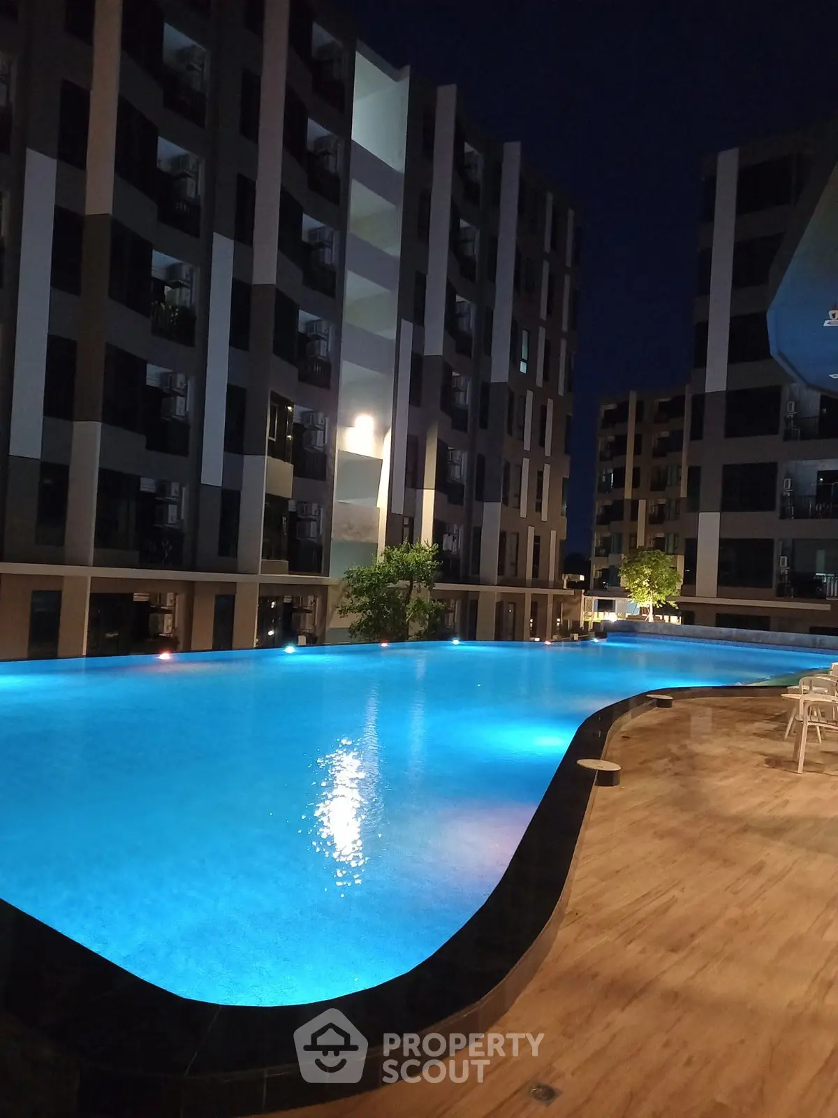 Luxurious residential complex with stunning illuminated pool at night