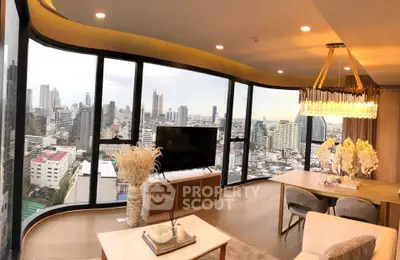 Luxurious living room with panoramic city views and elegant decor in a high-rise apartment.