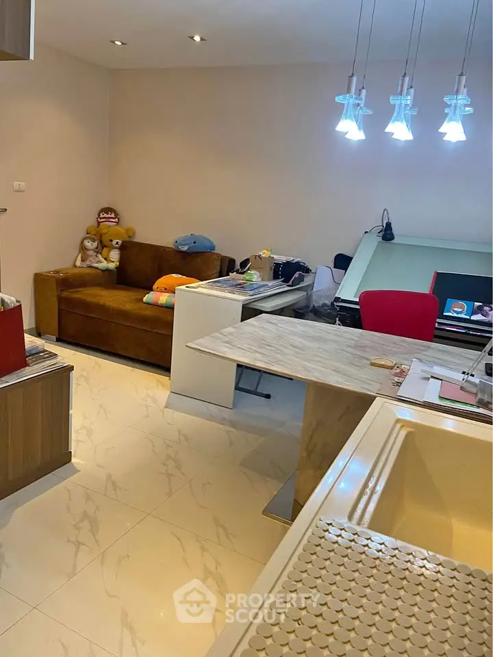 Cozy living room with modern lighting and marble-topped table