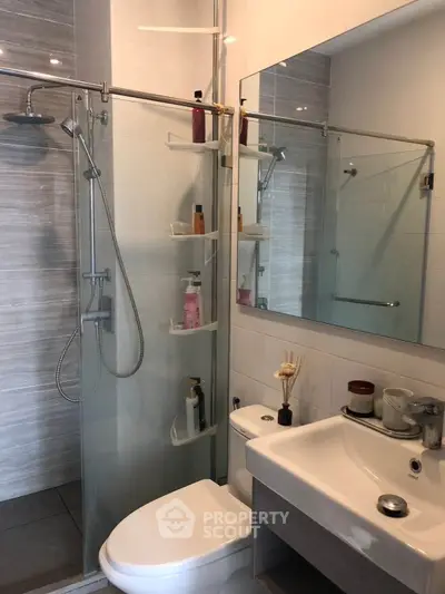 Modern bathroom with glass shower enclosure and sleek fixtures