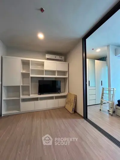Modern living room with sleek built-in shelving and hardwood floors
