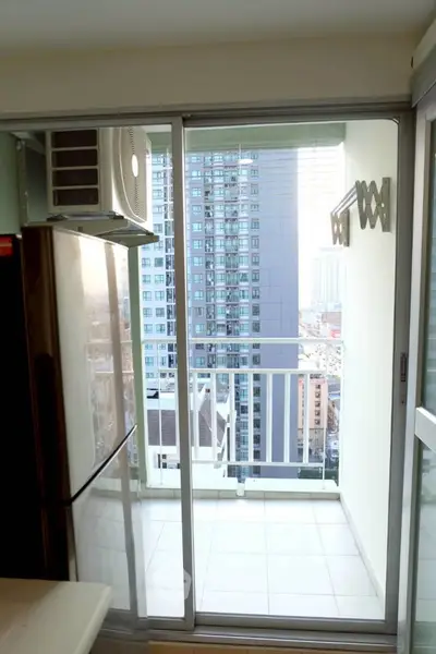 Modern apartment balcony with city view and sliding glass doors