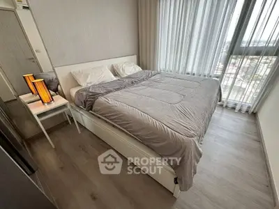 Modern bedroom with large window and stylish decor