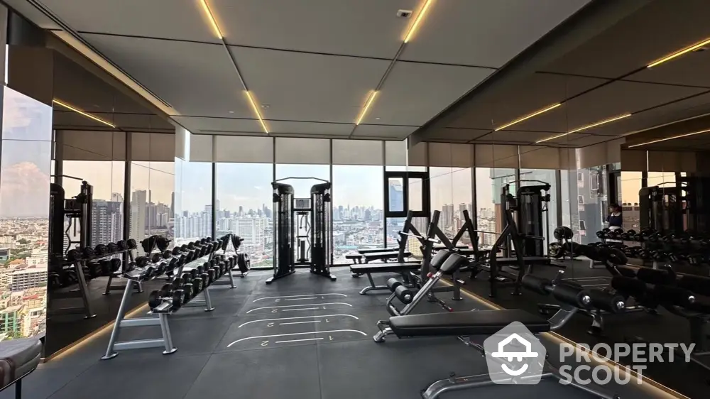 Luxurious high-rise gym with panoramic city views and modern fitness equipment.