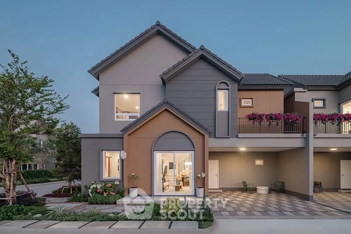 Modern two-story house with landscaped garden and spacious driveway at dusk.