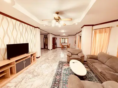 Spacious living room with elegant decor and cozy seating area, perfect for relaxation and entertainment.