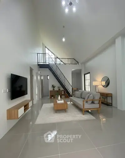 Spacious modern living room with high ceiling and stylish decor