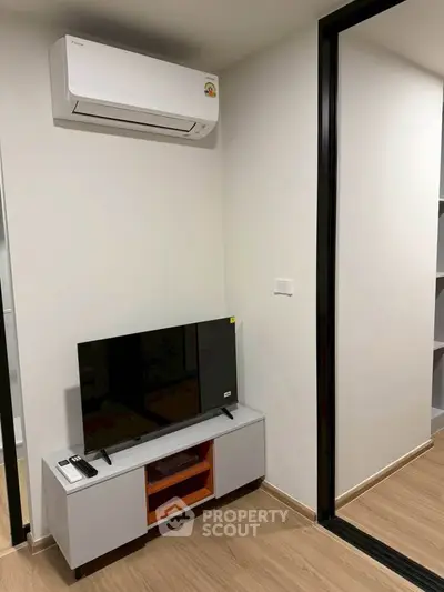 Modern living room with air conditioning and sleek TV setup
