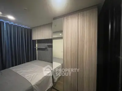 Modern bedroom with sleek wardrobe and cozy ambiance