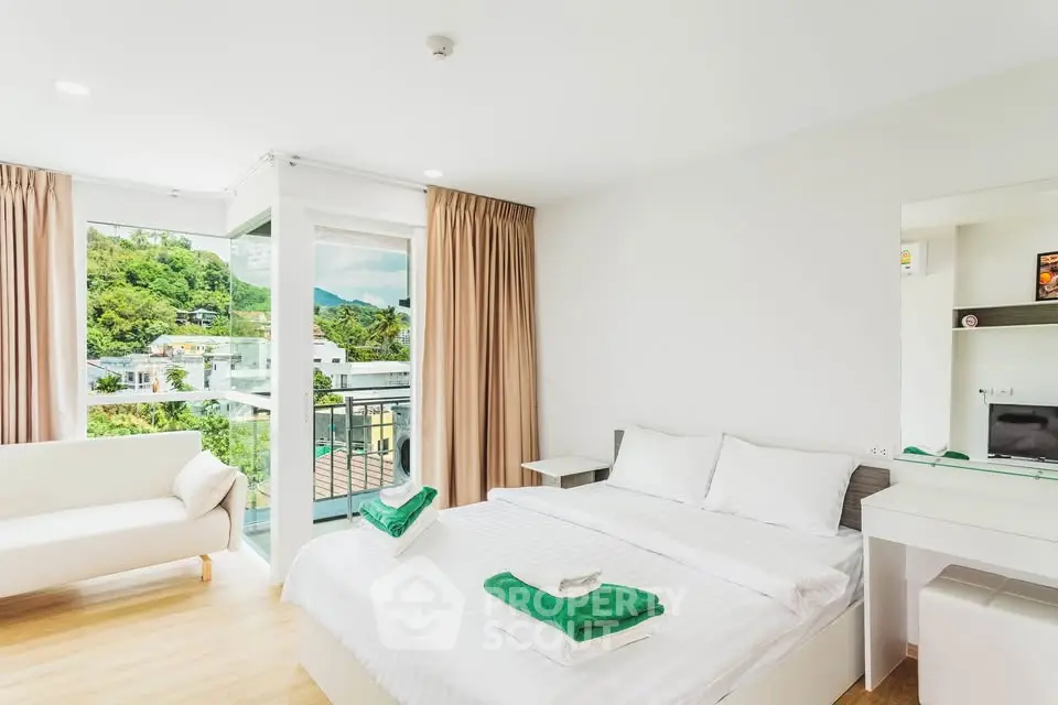 Bright and airy bedroom with balcony and scenic view in modern apartment.