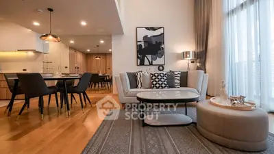 Luxurious open-plan living room with elegant decor and dining area, featuring modern furniture and ample natural light.