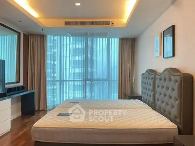 Spacious modern bedroom with large windows and elegant decor