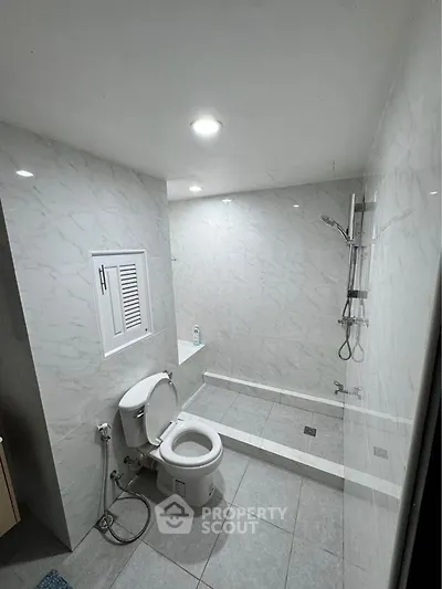 Modern bathroom with sleek marble tiles and walk-in shower