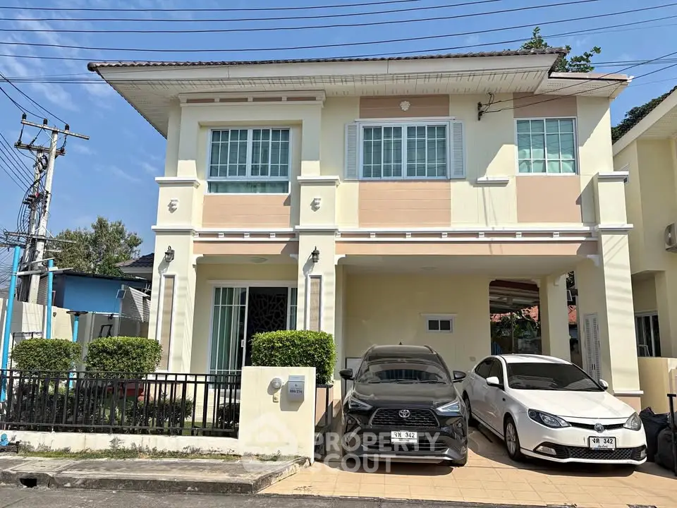 Charming two-story house with spacious driveway and modern facade in a serene neighborhood.