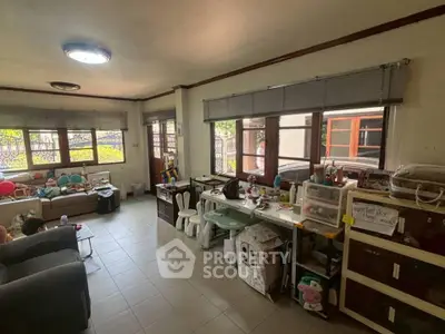 Spacious living room with large windows and ample natural light, perfect for family gatherings.