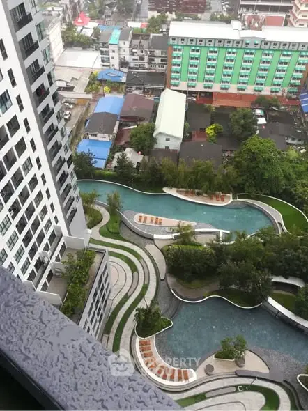 Stunning aerial view of modern residential complex with lush gardens and winding pathways.