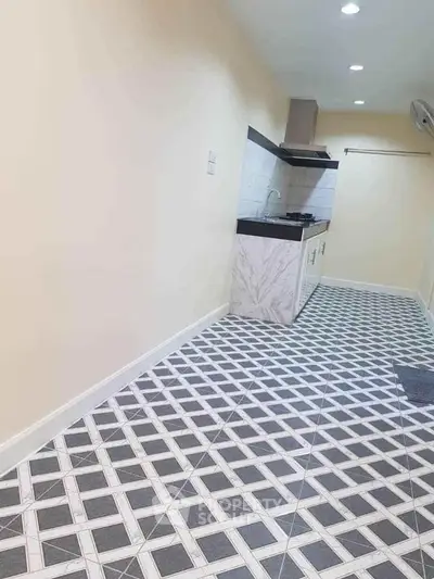 Modern kitchen with unique tiled flooring and sleek cabinetry