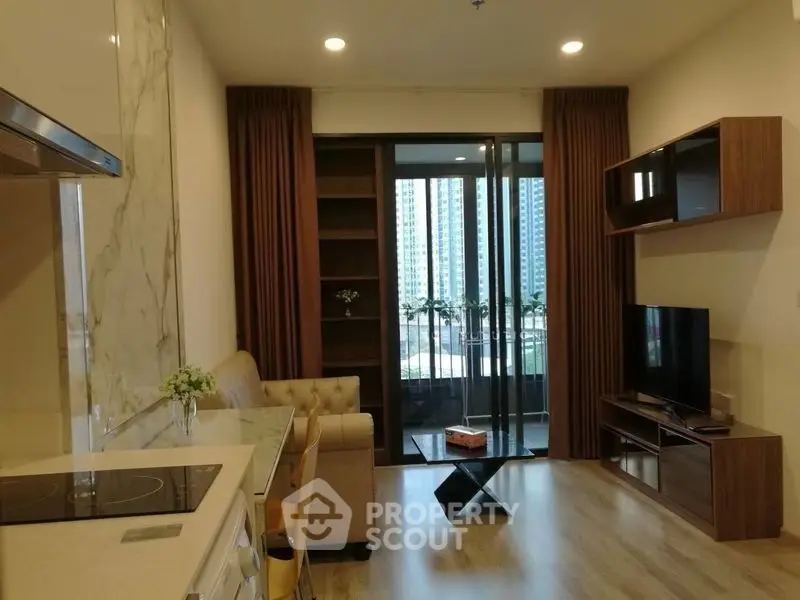 Modern living room with open kitchen and balcony view in urban apartment